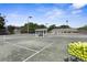 Two tennis courts with a shaded seating area at 3404 Rexford Cir, Ormond Beach, FL 32174