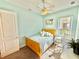 Bedroom with queen bed, ceiling fan, and rocking chair at 708 Aldenham Ln, Ormond Beach, FL 32174