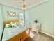 Bedroom with queen bed, ceiling fan, and rocking chair at 708 Aldenham Ln, Ormond Beach, FL 32174