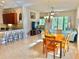 Open concept dining area with a wooden table and kitchen access at 708 Aldenham Ln, Ormond Beach, FL 32174
