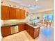 Open kitchen features a breakfast bar and views into the living room at 708 Aldenham Ln, Ormond Beach, FL 32174
