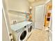 Laundry room with washer, dryer, and shelving unit at 708 Aldenham Ln, Ormond Beach, FL 32174
