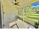 Relaxing screened porch with ceiling fan, offering a view of the backyard at 708 Aldenham Ln, Ormond Beach, FL 32174