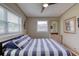 Spacious bedroom with a comfortable bed, dresser, and large windows at 2248 Nottingham Rd, South Daytona, FL 32119