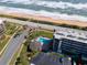 Aerial view of condo complex pool, parking and beach access at 3100 Ocean Shore Blvd # 201, Ormond Beach, FL 32176