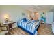 Spacious bedroom with a king-size bed and hardwood floors at 4525 S Atlantic Ave # 1403, Port Orange, FL 32127