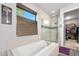 Modern bathroom featuring a soaking tub, walk-in shower, and a large closet at 660 Aldenham Ln, Ormond Beach, FL 32174