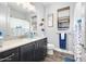 Stylish bathroom with dark cabinetry, a shower/tub combo, and a nautical theme at 660 Aldenham Ln, Ormond Beach, FL 32174