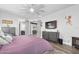 Primary bedroom with king-size bed, access to the bathroom, and a fireplace at 660 Aldenham Ln, Ormond Beach, FL 32174