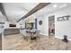 Open dining area with gray chairs, wood floors and view into the living room at 660 Aldenham Ln, Ormond Beach, FL 32174