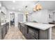 Modern kitchen with an island, stainless steel appliances, and dark cabinetry at 660 Aldenham Ln, Ormond Beach, FL 32174