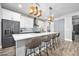 Modern kitchen island with seating, white and dark gray cabinets at 660 Aldenham Ln, Ormond Beach, FL 32174