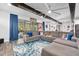 Spacious living room with L-shaped sectional sofa, wood beams, and large TV at 660 Aldenham Ln, Ormond Beach, FL 32174