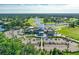 Aerial view of a clubhouse with parking and a golf course at 7 Jasmine Run, Ormond Beach, FL 32174