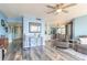 Living room with light blue walls, seating, and hardwood floors at 1 Oceans West Blvd # 19B3, Daytona Beach, FL 32118