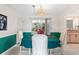 Dining room with a round table, teal tablecloth, and access to the kitchen at 2329 Oriole Ln, South Daytona, FL 32119