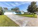 Light teal home with a large front yard and driveway at 2329 Oriole Ln, South Daytona, FL 32119