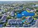Aerial view of condo building near lake with fountain at 940 Village Trail # 7-107, Port Orange, FL 32127