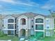 Two-story building with balconies and stone accents at 940 Village Trail # 7-107, Port Orange, FL 32127