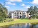 Two-story building with balconies overlooking a lake at 940 Village Trail # 7-107, Port Orange, FL 32127