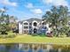 Two-story building with balconies overlooking a lake at 940 Village Trail # 7-107, Port Orange, FL 32127