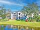 Condo building exterior showcasing architectural details and waterfront view at 940 Village Trail # 7-107, Port Orange, FL 32127