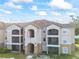 Two-story building with balconies and stone accents at 940 Village Trail # 7-107, Port Orange, FL 32127