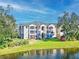 Condo building exterior showcasing architectural details and waterfront view at 940 Village Trail # 7-107, Port Orange, FL 32127
