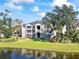 Two-story building with balconies overlooking a lake at 940 Village Trail # 7-107, Port Orange, FL 32127
