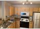 Well-equipped kitchen featuring ample cabinetry and appliances at 940 Village Trail # 7-107, Port Orange, FL 32127