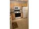 Efficient kitchen with wood cabinets and modern appliances at 940 Village Trail # 7-107, Port Orange, FL 32127