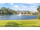Serene lakefront property with lush landscaping and fountain at 940 Village Trail # 7-107, Port Orange, FL 32127