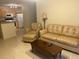Open living room with view into kitchen and neutral decor at 940 Village Trail # 7-107, Port Orange, FL 32127