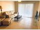 Bright living room with tiled floors and comfy leather furniture at 940 Village Trail # 7-107, Port Orange, FL 32127