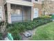 Screened patio with view of landscaping and parking at 940 Village Trail # 7-107, Port Orange, FL 32127