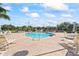 Community pool with lounge chairs and patio area at 940 Village Trail # 7-107, Port Orange, FL 32127