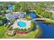 Community pool with lake and lush landscaping at 940 Village Trail # 7-107, Port Orange, FL 32127