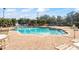 Relaxing community pool with lounge chairs and patio area at 940 Village Trail # 7-107, Port Orange, FL 32127
