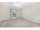 Spacious carpeted bedroom with window and ceiling fan at 1300 Benton Lake E Dr, Deland, FL 32724