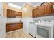 Laundry room with wooden cabinets, washer, and dryer at 501 Oyster Bay Dr, Ormond Beach, FL 32174