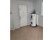 Utility room with water heater and tiled flooring at 118 Deacon Jones Blvd, Orlando, FL 32810