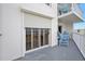 Private balcony with seating and shuttered sliding door at 1183 Ocean Shore Blvd # 1040, Ormond Beach, FL 32176