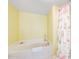 Bright bathroom with a soaking tub and decorative shower curtain at 1183 Ocean Shore Blvd # 1040, Ormond Beach, FL 32176