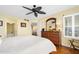 Spacious bedroom with ceiling fan, wooden furniture, and en-suite bathroom access at 1183 Ocean Shore Blvd # 1040, Ormond Beach, FL 32176