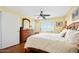 Comfortable bedroom with ceiling fan, wooden dresser, and ocean view at 1183 Ocean Shore Blvd # 1040, Ormond Beach, FL 32176
