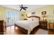 Relaxing bedroom with ceiling fan, wooden furniture, and ocean view at 1183 Ocean Shore Blvd # 1040, Ormond Beach, FL 32176