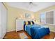 Cozy bedroom with white wicker furniture and blue bedding at 1183 Ocean Shore Blvd # 1040, Ormond Beach, FL 32176