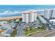 Aerial view of a beachfront condominium building with parking and nearby amenities at 1183 Ocean Shore Blvd # 1040, Ormond Beach, FL 32176