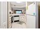 Compact kitchen with white appliances, ample counter space, and ocean view at 1183 Ocean Shore Blvd # 1040, Ormond Beach, FL 32176