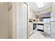 Functional kitchen with white appliances, storage closet, and ocean view at 1183 Ocean Shore Blvd # 1040, Ormond Beach, FL 32176